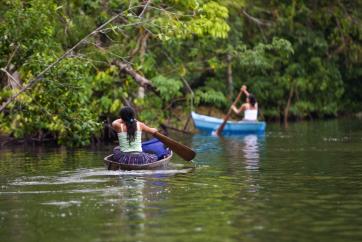 People navigating a river in a canoe